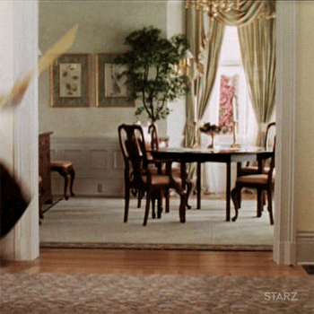 Gif of Robin Williams as Mrs. Doubtfire jumping and dancing with a broom